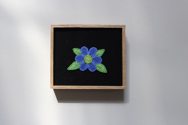 Small beaded artwork in oak frame
